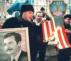 Members of Russia's ultra-nationalist Liberal Democratic Party burn a  US flag.