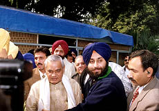 Mr Sukhbir Singh Badal, Union Minister of State for Industry greeting Mr Atal Behari Vajpayee, Prime Minister of India at his residence on his 75th birthday at New Delhi — T.C. Malhotra