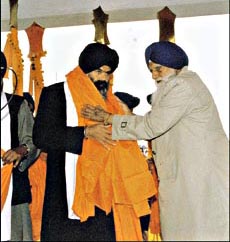 SGPC chief Gurcharan Singh Tohra presenting siropa to Akal Takht chief Bhai Ranjit Singh at Fatehgarh Sahib on Sunday.