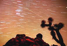 A meteor streaks through the sky.