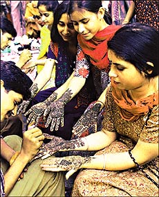 Mehndi being applied to the hands of women on the eve of Karva Chauth in Chandigarh on Wednesday. 