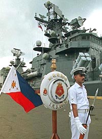 An Indian sailor guards an entrance of the INS Delhi warship in Manila's pier on Sunday.