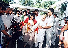 Delhi rural Congress workers led by Bharat Kesari Sanjay Pehlwan and Mr Anil Bali present a cow and a calf to Mrs Sonia Gandhi