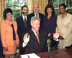 President Clinton has a laugh after finishing his weekly radio address in the Oval Office on Saturday. President Clinton was joined by National Drug Control Policy Director Barry McCaffrey (behind Clinton) and others.