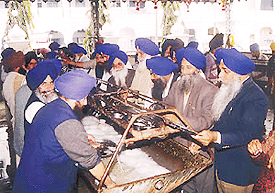 Executive members of the SGPC wash utensils as part of ‘tankhah’ (punishment) at the Golden Temple on Thursday.