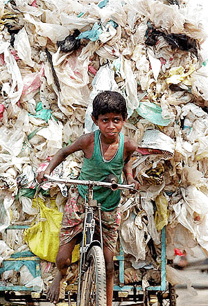 Ten-year-old Ravi Pradhan cycles a cartload of plastic bags for recycling in Calcutta on Sunday. Ravi contributes Rs 25 daily to his family’s income by supplying plastic to the recycling indusry. Thousands of such poor people, mostly children, earn their living from plastic goods recycling in Calcutta