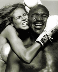 Model Heidi Klum initates Mike Tyson's infamous biting of american heavyweight pugilist Evander Holyfield's ear as they pose in the 2000 sports Illustrated swim suit issue