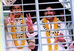 Undertrial prisoners Suraj Bhan alias Dada and Rajan receive garlands and wave to their supporters from jail after winning in the Bihar Assembly election.