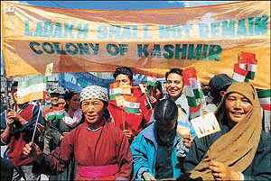 People of the Buddhist-majority region of Ladakh in Jammu and Kashmir hold the national flag and shout slogans during a rally in Leh on Monday. 