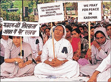 Members of the Christian community from Delhi and neighbouring districts of Uttar Pradesh and Haryana hold banners and pray for peace and democracy in India at Raj Ghat in old Delhi on Sunday.