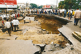 A road caves in after floods in Hyderabad city on Friday. Helicopters plucked people from apartments 
