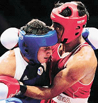 Jitender Kumar of India (right) and Romanias Adrian Diaconu in action during their second round 75 kg middleweight boxing match at the Sydney Olympics on Friday.