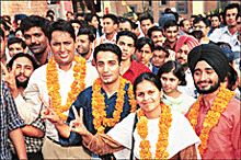Bhupinder Singh 'Bhuppi' of the PUSU-ABVP-HSA alliance makes the 'V' sign after being elected Chairman of the Punjab University Campus Students Council on Friday.
