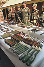 An Indian Army officer displays a seized mortar and other arms and ammunition at an Army camp in Pattan, 27 km north of Srinagar, on Sunday. Reuters photo