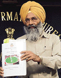 Union Sports Minister Sukhdev Singh Dhindsa shows a report prepared by the Central Bureau of Investigation on match-fixing at a news conference in New Delhi on Wednesday