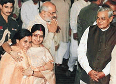 Prime Minister Atal Behari Vajpayee watches new Cabinet colleague Uma Bharati as she is hugged by Information and Broadcasting Minister Sushma Swaraj soon after the Cabinet expansion in New Delhi on Tuesday.