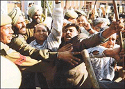 Policemen try to stop demonstrators in Jammu on Saturday. 