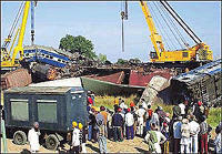 Railway and rescue workers use cranes to remove wrecked carriages of the Howrah-Amritsar Express 