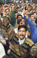 Postal workers shout anti-government slogans near Parliament House in Delhi on Friday