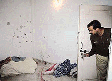 A Delhi police officer looks at a room in which a Pakistani militant was shot dead on Tuesday.