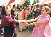 Foreign tourists dressed in traditional saris dance while Indians join in the festivities during a Hare Krishna procession at the Mahakumbh Mela in Allahabad on Wednesday