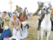 Mounted police asks devotees to move on after taking a holy dip in the Ganga during the Mahakumbh Mela in Allahabad on Sunday. 