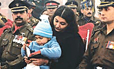 Ms Poonam Guleria, wife of late Capt Deepak Guleria, holds the Sena Medal which she received on behalf of her husband (posthumously) during the Army Day parade in New Delhi on Monday.