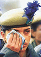 A paramilitary trooper wipes her tears during the wreath laying ceremony of four dead colleagues
