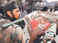 Soldiers carry an elderly woman survivor of the Gujarat earthquake who was rescued after being trapped for more than 72 hours in Bhuj city on Monday. 