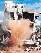 Army jawans conduct a controlled blast in one of the city apartments affected by the killer quake to help the rescue work on Thursday evening. 