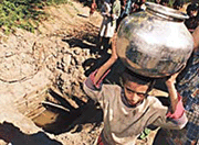 Water from a contaminated ground well is carried by a boy in Luna, a village on the border in Gujarat state, on Friday. 