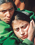 Mourning the death of six Sikhs, an unidentified Kashmiri Sikh girl is consoled by another woman in Srinagar on Sunday. 