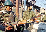 Paramilitary forces guard a police post in Srinagar on Saturday. 