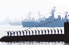 Crew members of an Indian submarine salute as the presidential yacht passes them in waters off Bombay on Saturday.