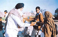 A SAD leader distributes jalebis in Dialpur Tapprian village, which is dominated by migrant labourers, during the Majitha byelection on Monday.