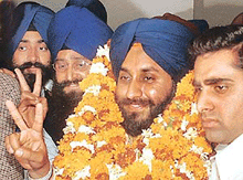 Sukhbir Badal shows the victory sign after being elected as a Rajya Sabha member in Chandigarh on Thursday.