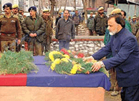 Jammu and Kashmir Public Health Minister Ali Mohammad paying tribute to the slain cops of Kokernag at the district headquarters in Anantnag on Saturday.