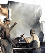Security personnel douse a fire started during communal riots in Kanpur on Sunday.