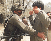 A paratrooper frisks a youth in Srinagar on Friday.