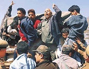 Shia and Sunni supporters of the All-Party Hurriyat Conference (APHC) shout slogans after being arrested during the Muharram procession in Srinagar on Thursday.