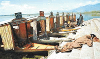 A boatman takes a nap as shikaras stand idle, waiting for prospective visitors to Dal Lake in Srinagar on Sunday.