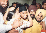 Harbhajan Singh, the new international cricket icon, is greeted by his mother on arrival at his residence in Jalandhar on Sunday. 