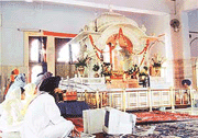 MODERNITY IN TRADITION: A sevadar in Gurdwara Rakab Ganj entering the daily collection data into a computer