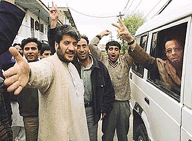 Kashmiri separatist leader Shabir Shah (second from left) and his supporters raise victory slogans as his special envoy Saleem Geelani (right) flashes a V-sign prior to his departure for talks in Delhi on Monday.