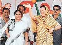 Sonia Gandhi (right), President of the Congress party, and Mamata Banerjee, leader of the Trinamool Congress, wave to supporters before a meeting in Kharagpur.