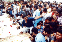 Local residents and relatives prepare the remains of eight ruling Asom Gana Parishad (AGP) party workers for last rites in Bogrihati, near Guwahati, on Friday.