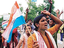 People from all walks of life, including AGP and BJP supporters, shout slogans at a rally. 