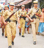 Armed policemen march through a road on the eve of the Assembly elections in Kolcata on Thursday.