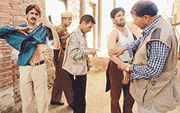 Nissar Ahmed (right), photographer of The Hindu, and Associated Press Television news cameraman Merajuddin (third from right) help Reuters Srinagar photographer Fayaz Kabli (second from right) with his wounds at Magam, 15 km west of Srinagar, on Thursday.