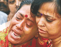 Sadhana Das (left) mourns the death of her husband, Rabindra Nath, who died during Thursdays poll-related violence in Kolkata on Friday. 